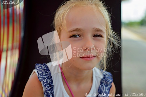 Image of Little girl sitting on the bench