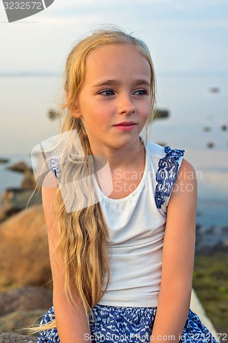 Image of Portrait of little beautiful girl on sunset