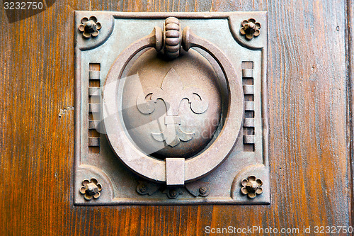 Image of   knocker in a  door curch  closed wood italy   cross