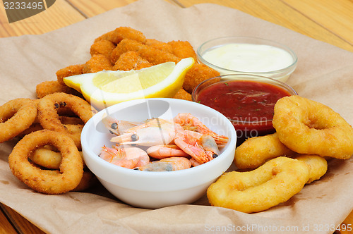 Image of beer snack, shrimps, calmar rings and fish sticks