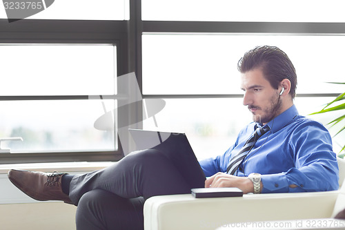 Image of Businessman in office working on his laptop. 