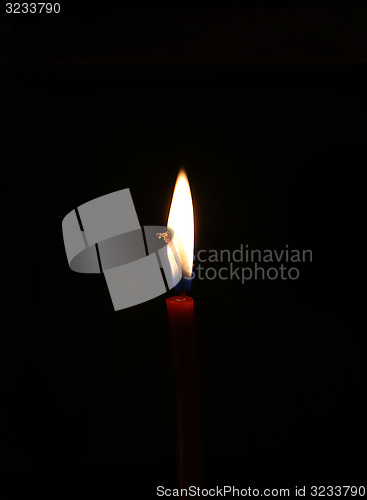 Image of Burning candle in the dark