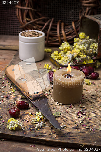 Image of medicinal herb and burning candle