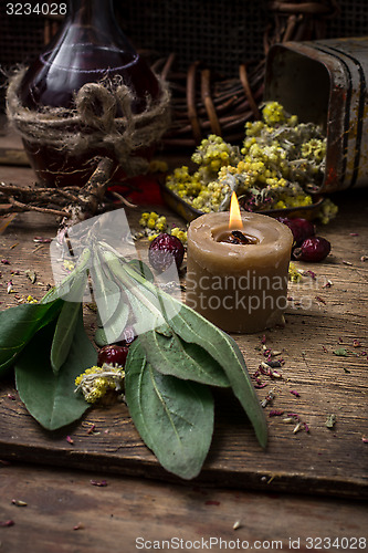 Image of medicinal herb and burning candle