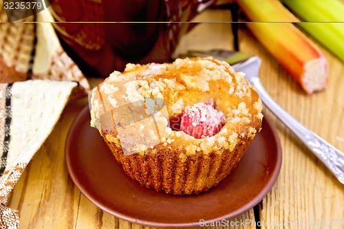 Image of Cupcake rhubarb on plate with cup and napkin