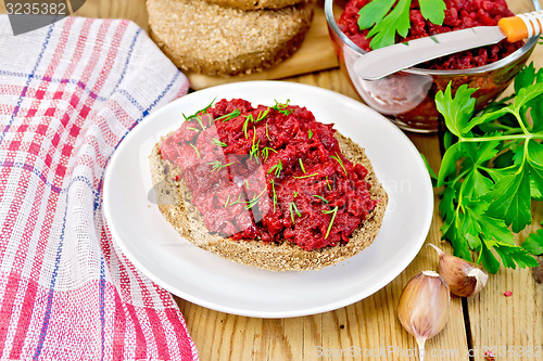 Image of Sandwich with beet caviar on wooden board