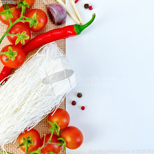 Image of Frame of funchoza and tomatoes with paper on sacking