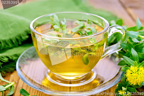 Image of Herbal tea with Rhodiola rosea and napkin on board