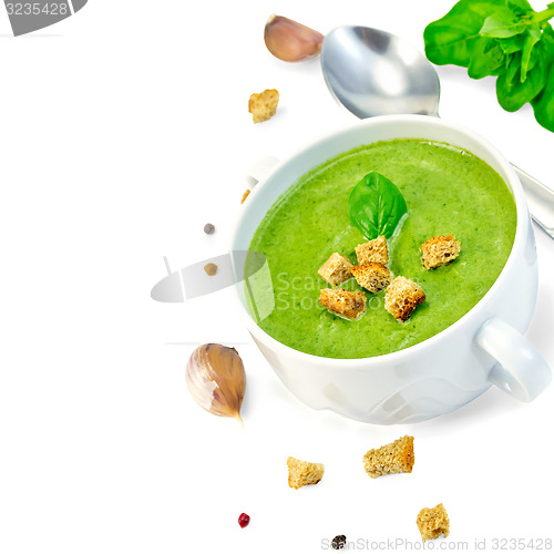 Image of Soup puree with croutons and spoon in bowl
