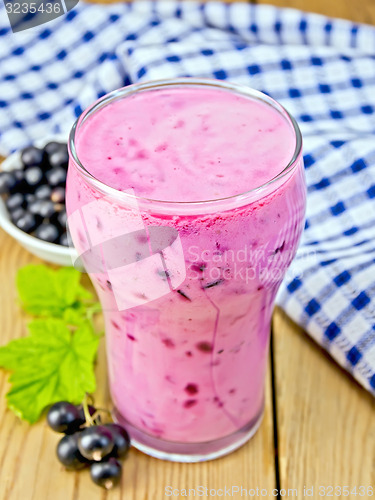 Image of Milkshake with black currant and leaves on board