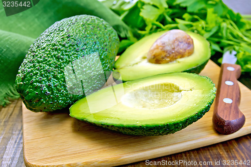 Image of Avocado with parsley on board