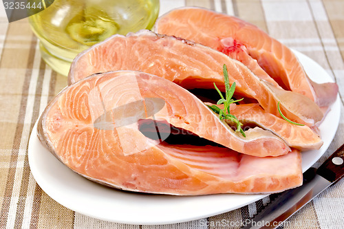 Image of Trout in plate with rosemary and oil on napkin