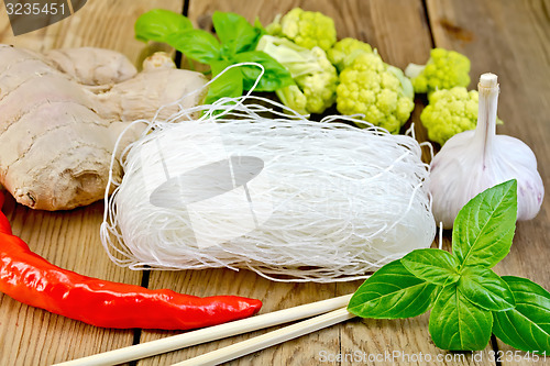 Image of Noodles rice thin with vegetables and spices on board