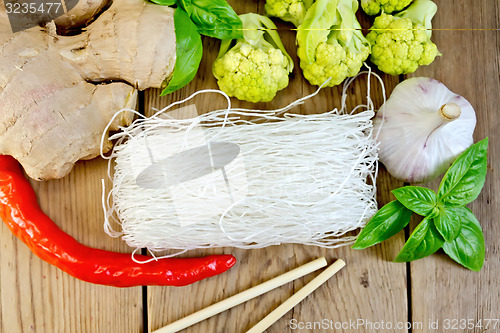 Image of Noodles rice thin with broccoli and spices on board