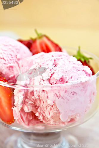 Image of Ice cream strawberry in glass bowl on board