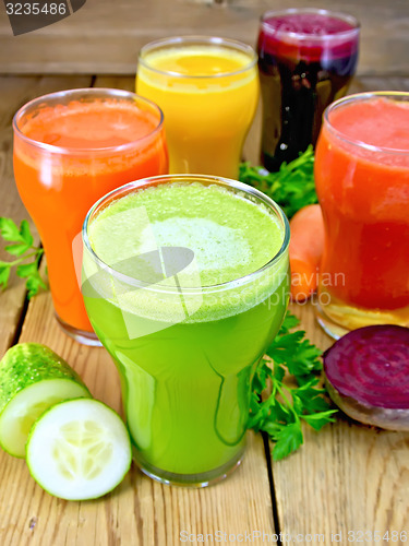 Image of Juice cucumber and vegetable in glassful on board