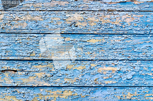 Image of Old board with peeling blue paint