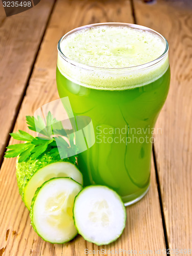 Image of Juice cucumber in tall glassful on board