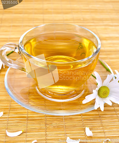 Image of Herbal tea with camomiles on bamboo napkin