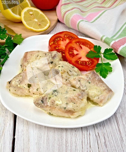 Image of Fish stew in sauce on plate with lemon