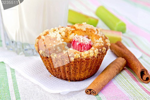 Image of Cupcake with rhubarb and milk on linen napkin