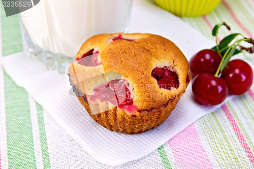 Image of Cupcake with cherries and milk on linen napkin