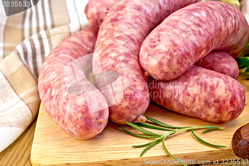Image of Sausages pork on board with napkin