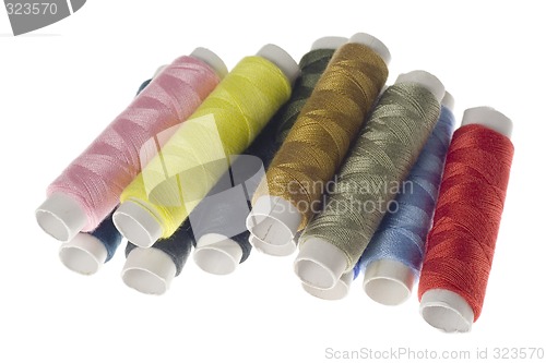 Image of Rows of colorful sewing threads


