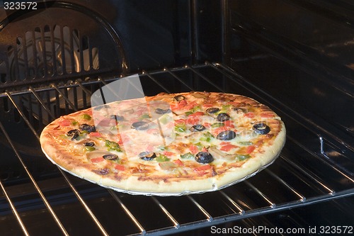 Image of Vegetarian pizza in oven

