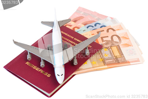 Image of Passport with toy plane and money