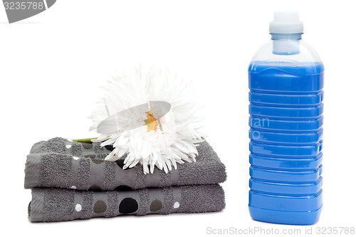 Image of Laundry detergent with towels and flower