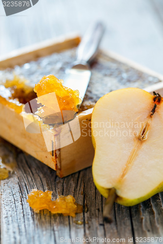 Image of Honey comb and ripe pear.