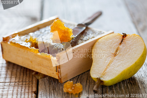 Image of Honey comb and a slice of pear.