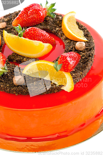 Image of Cake red glaze with strawberry and orange slices.