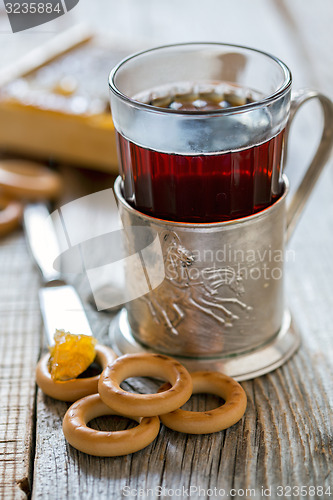 Image of Glass of tea in an old cup holder.