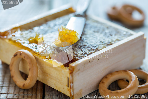 Image of Honey in the comb and small bagels.