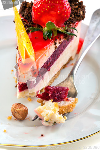 Image of Plate of cake with fresh strawberries and orange.