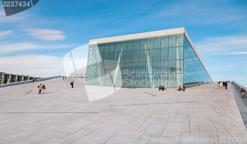 Image of People walking on the roof of the Oslo Opera House. The Oslo Opera House is home The Norwegian National Opera and Ballet, and the National Opera Theatre.