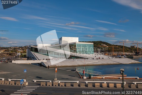 Image of OSLO, NORWAY - May 4, 2011: People walking on the roof of the Oslo Opera House. The Oslo Opera House is home The Norwegian National Opera and Ballet, and the National Opera Theatre.