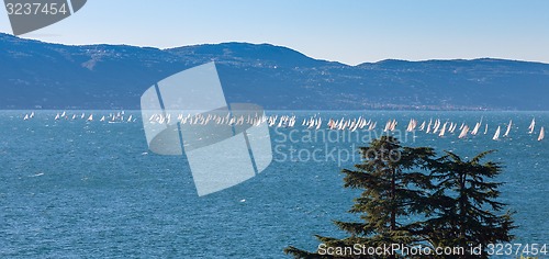 Image of Sail boat on a lake with mountains as background