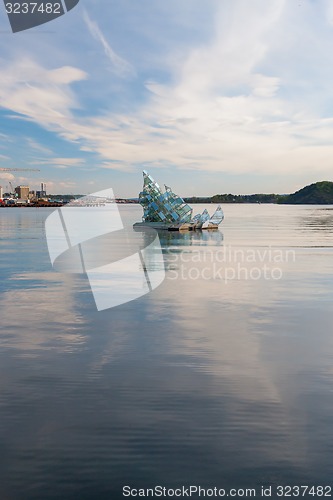 Image of OSLO - May 4, 2011.  \'She Lies\' is the name of a floating glass and steel construction that turns with the wind and tide, created by Monica Bonvicini; May 4, 2011 near the Opera House, Oslo, Norway.