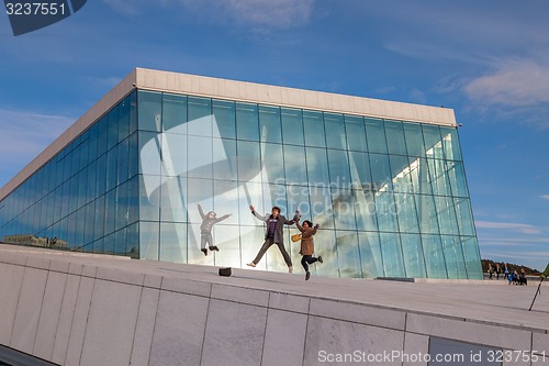 Image of People walking on the roof of the Oslo Opera House. The Oslo Opera House is home The Norwegian National Opera and Ballet, and the National Opera Theatre.