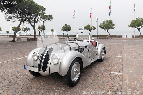 Image of SIRMIONE, Province of Brescia,  ITALY - MAY 08 unidentified crew on an old car BMW 328 coupe 1938 in italian historical rally Mille Miglia 2014, on May 08, 2014 in  Lake Garda town of Sirmione, Italy