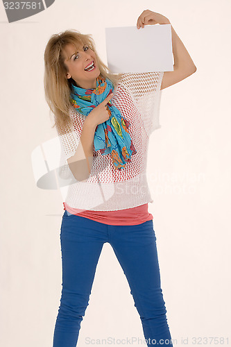 Image of Stylish woman smiling with blank shield in the hand