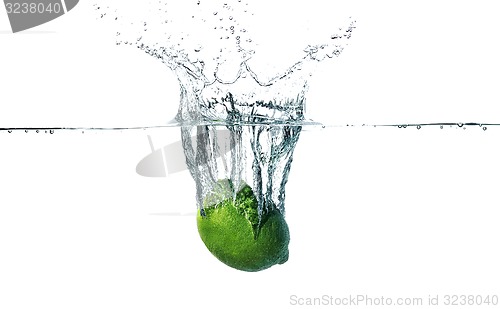 Image of Fresh lime falling into water