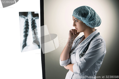Image of Image of attractive woman doctor looking at x-ray results