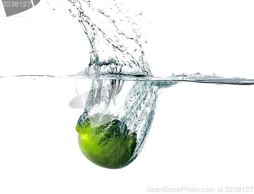 Image of Fresh lime falling into water