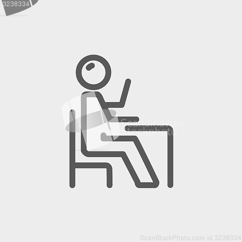 Image of Student sitting on a chair in front of his table thin line icon