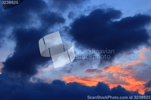 Image of sunset with dark blue and crimson clouds