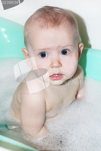 Image of little baby takes a bath